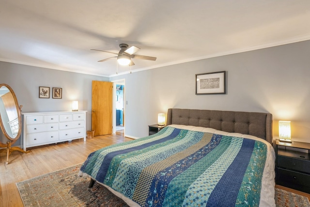 bedroom with baseboards, ornamental molding, ceiling fan, and wood finished floors