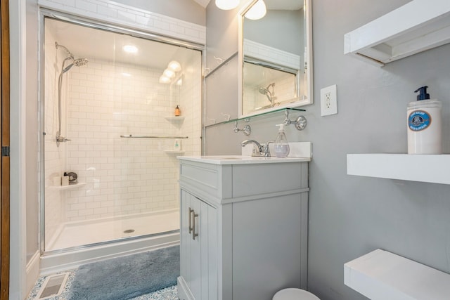 full bathroom with vanity and a stall shower