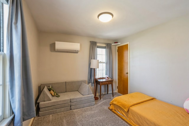 bedroom featuring baseboards, a wall mounted air conditioner, and carpet