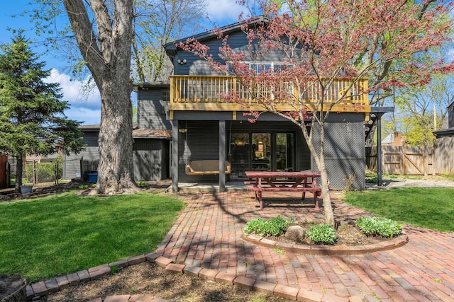 back of property featuring a lawn, a gate, a patio area, and fence
