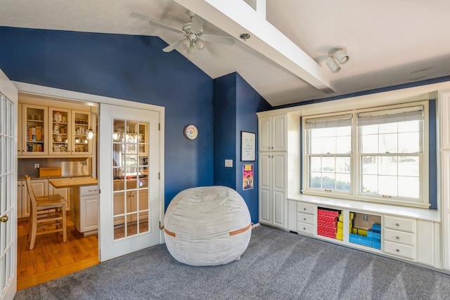 recreation room with carpet, a ceiling fan, and vaulted ceiling