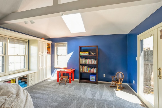 recreation room featuring carpet floors, baseboards, and vaulted ceiling with skylight