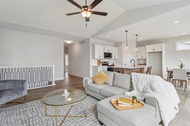 living area featuring recessed lighting, ceiling fan, light wood finished floors, and visible vents