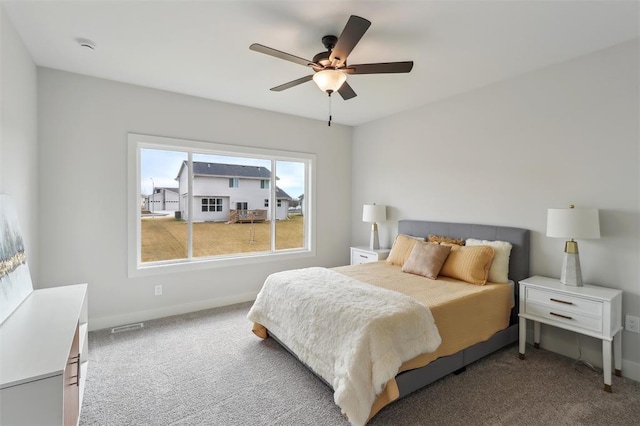 carpeted bedroom featuring a ceiling fan, baseboards, and visible vents