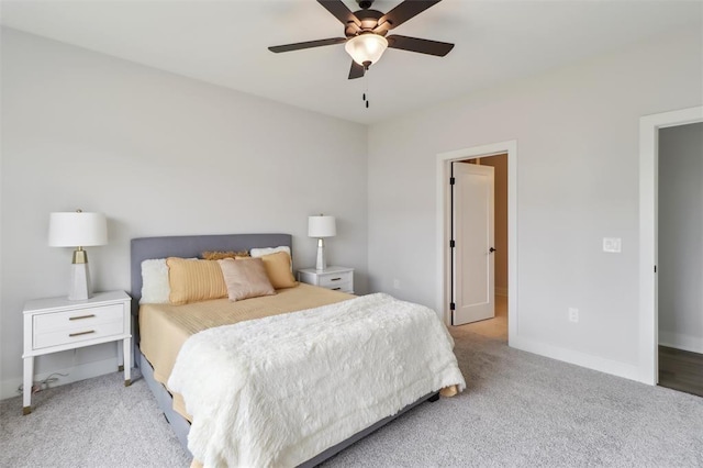 carpeted bedroom featuring baseboards and ceiling fan