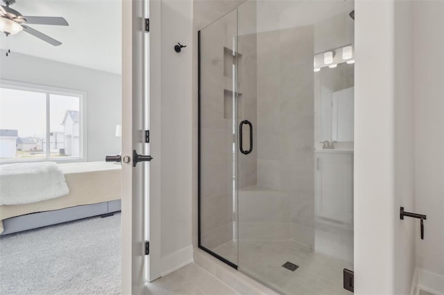 bathroom featuring ensuite bathroom, a ceiling fan, baseboards, and a stall shower