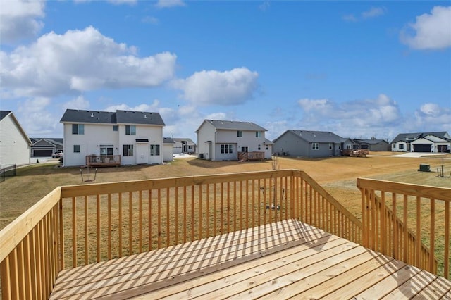 wooden deck featuring a yard and a residential view