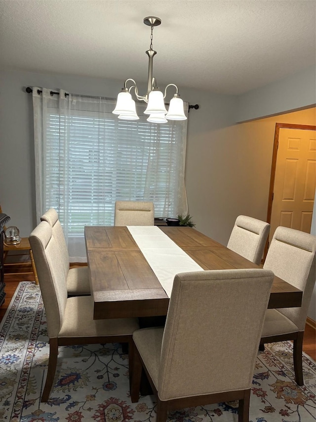 dining room with an inviting chandelier and wood finished floors