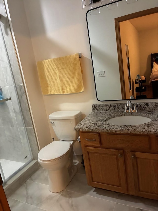 full bathroom featuring vanity, a stall shower, and toilet