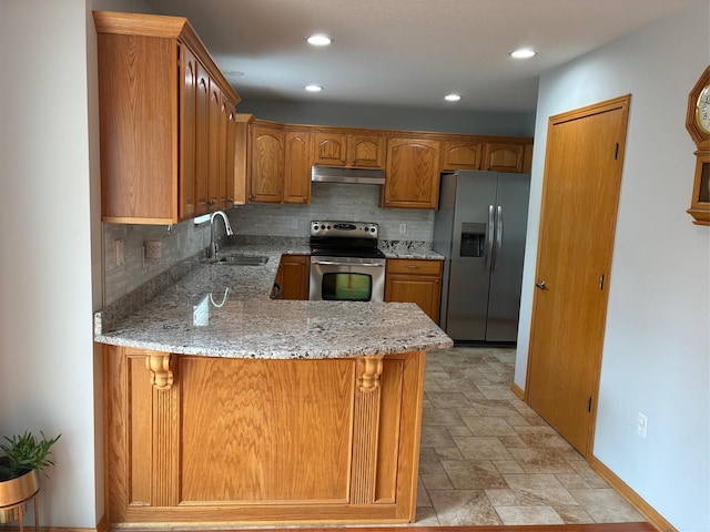 108 S 46th St, West Des Moines, IA 50265 - kitchen featuring appliances with stainless steel finishes, a sink, under cabinet range hood, backsplash, and stone finish floors