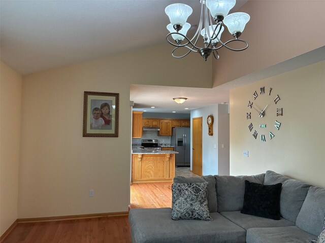 108 S 46th St, West Des Moines, IA 50265 - living area featuring vaulted ceiling, light wood finished floors, a chandelier, and baseboards