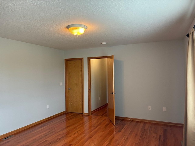 108 S 46th St, West Des Moines, IA 50265 - unfurnished room featuring light wood-style floors, baseboards, a textured ceiling, and a smoke detector