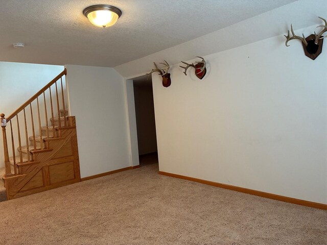 108 S 46th St, West Des Moines, IA 50265 - spare room with light carpet, baseboards, a textured ceiling, and stairway