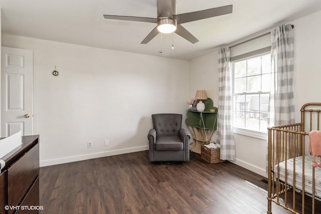 sitting room featuring a ceiling fan, baseboards, and wood finished floors