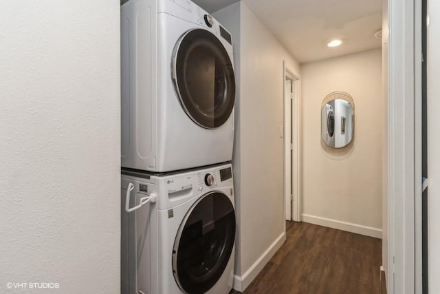 laundry room with laundry area, stacked washer and clothes dryer, baseboards, dark wood-type flooring, and recessed lighting
