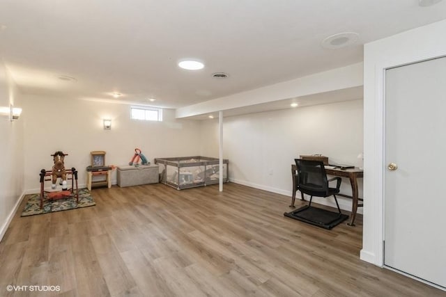 interior space with light wood-style floors, baseboards, and visible vents