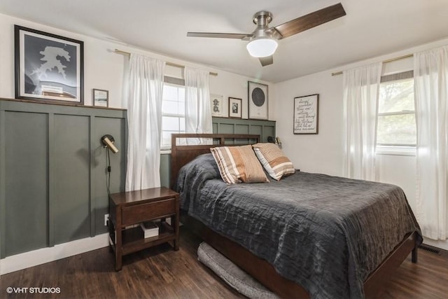bedroom with visible vents, a ceiling fan, and dark wood finished floors