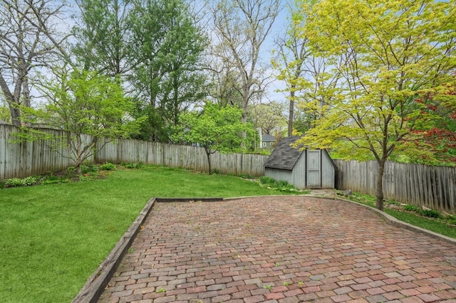 view of patio / terrace featuring a storage shed, an outbuilding, and a fenced backyard