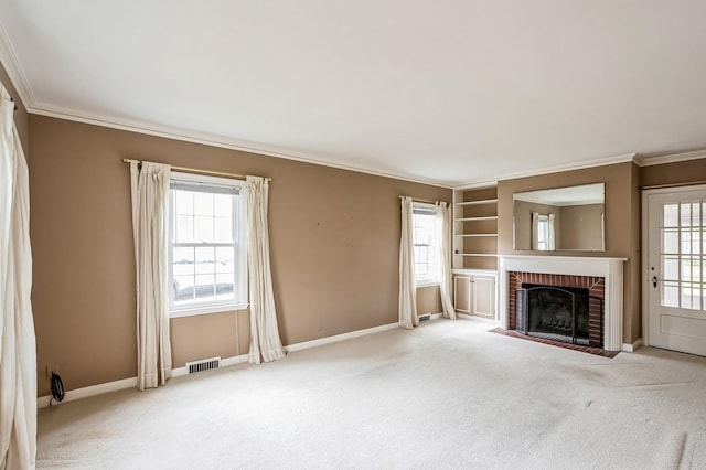 unfurnished living room featuring plenty of natural light, ornamental molding, carpet flooring, and visible vents