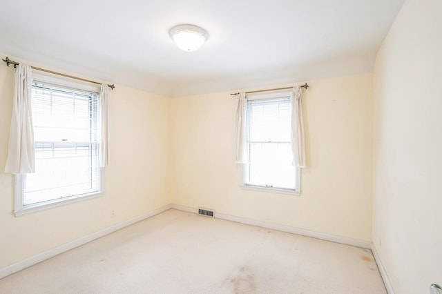 unfurnished room featuring visible vents, baseboards, and carpet floors
