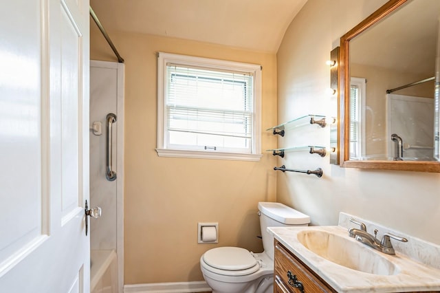 bathroom featuring vanity, toilet, baseboards, shower / bath combination, and vaulted ceiling