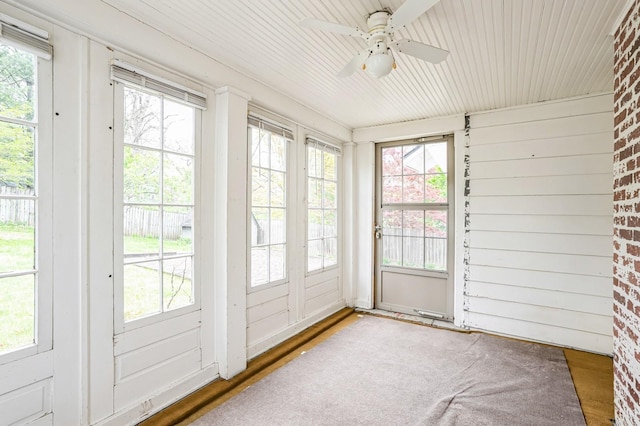 unfurnished sunroom featuring french doors, plenty of natural light, and a ceiling fan