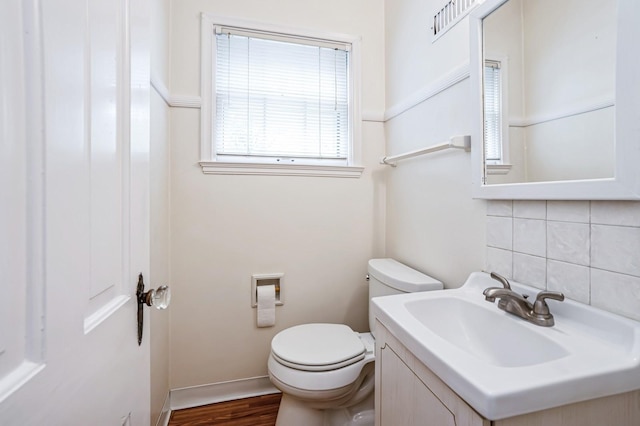 348 49th St, Des Moines, IA 50312 - bathroom featuring backsplash, vanity, and wood finished floors