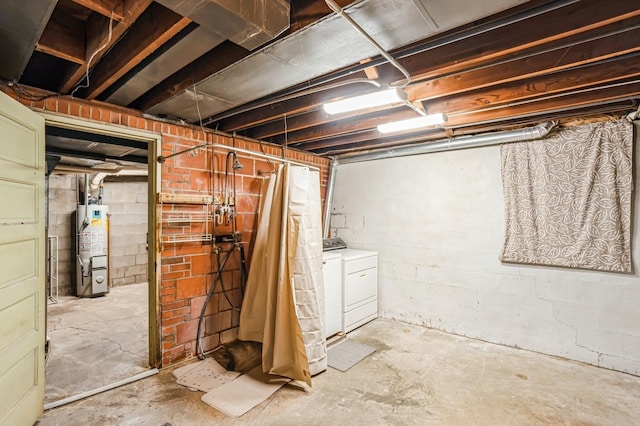 unfinished basement with washing machine and clothes dryer and gas water heater