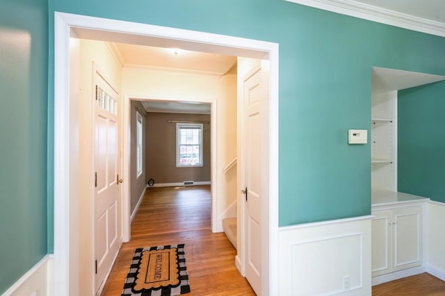 348 49th St, Des Moines, IA 50312 - hallway with crown molding and light wood-style flooring