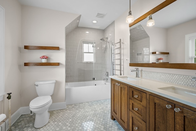 bathroom featuring toilet, visible vents, plenty of natural light, and a sink