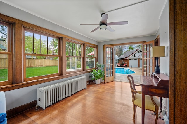 sunroom / solarium featuring radiator