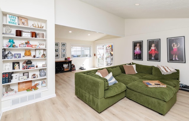 living area featuring recessed lighting, visible vents, light wood-type flooring, and lofted ceiling