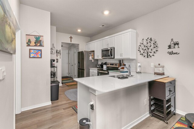 2601 NW 30th Ln, Ankeny, IA 50023 - kitchen with a sink, baseboards, light wood-style floors, and stainless steel appliances