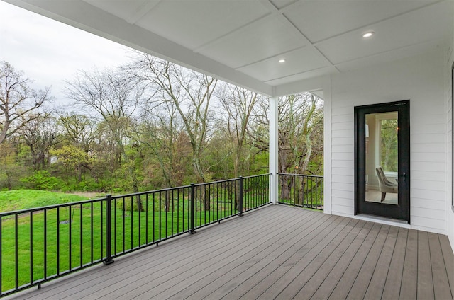 wooden deck featuring a yard