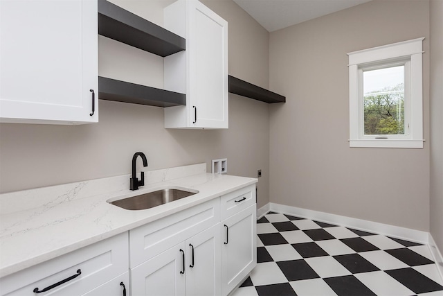laundry area with cabinet space, a sink, hookup for a washing machine, tile patterned floors, and electric dryer hookup