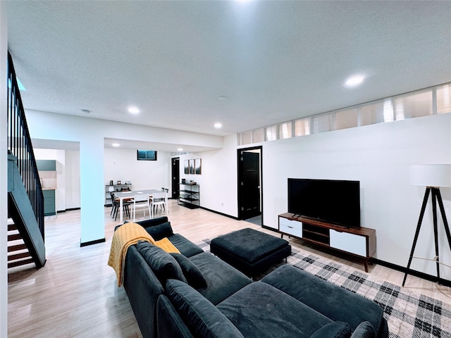 living area with stairs, recessed lighting, baseboards, and wood finished floors