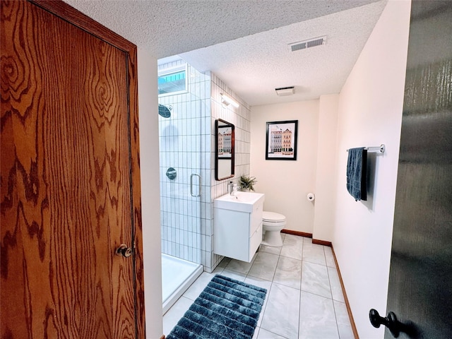 full bathroom with vanity, toilet, a textured ceiling, baseboards, and a shower stall