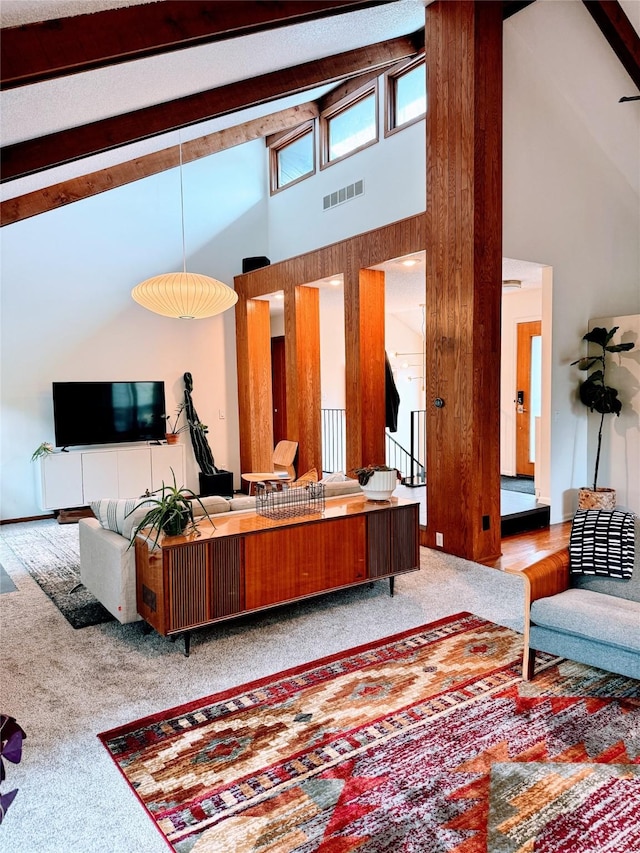 living area featuring high vaulted ceiling, carpet flooring, beam ceiling, and visible vents