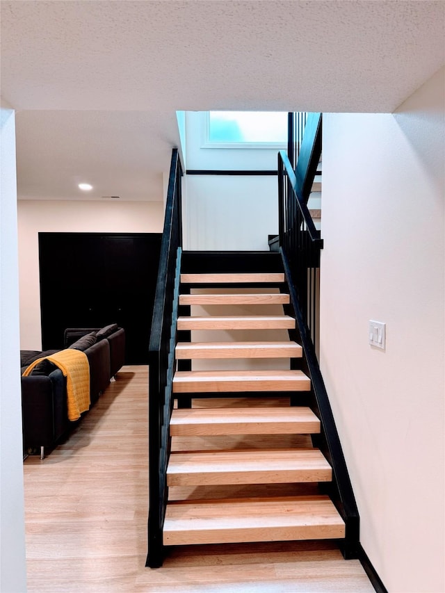 stairway with wood finished floors