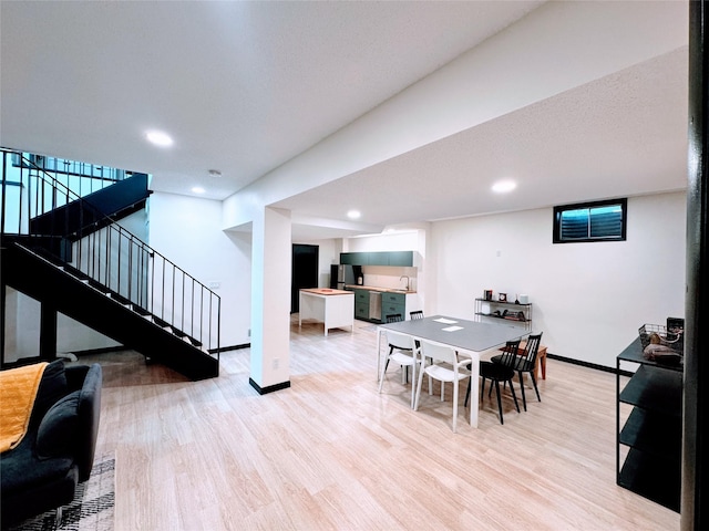 dining area featuring stairs, recessed lighting, baseboards, and light wood-style floors