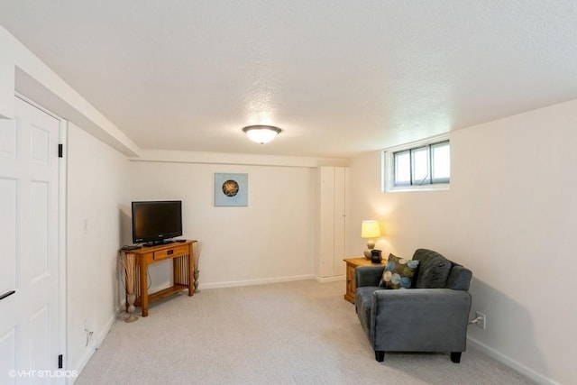 living area with baseboards and light carpet