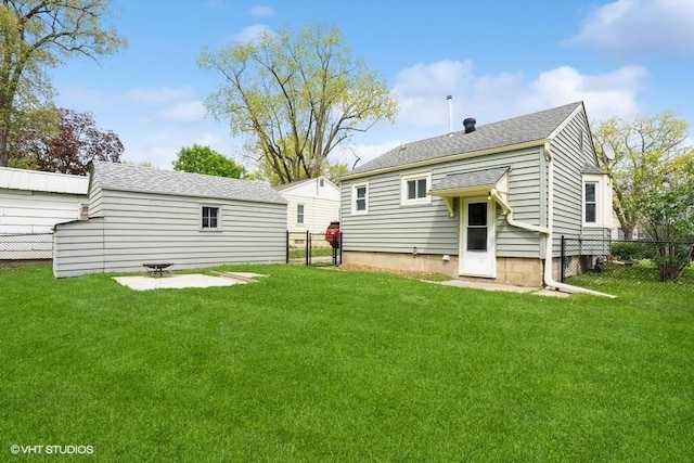 back of house with a lawn and fence
