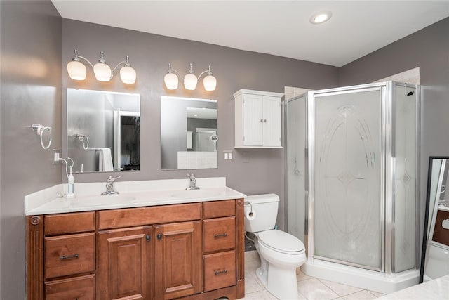 full bathroom featuring a sink, tile patterned floors, a shower stall, and toilet