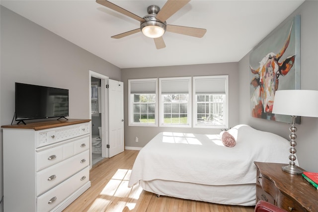 bedroom with light wood-style floors, baseboards, and a ceiling fan