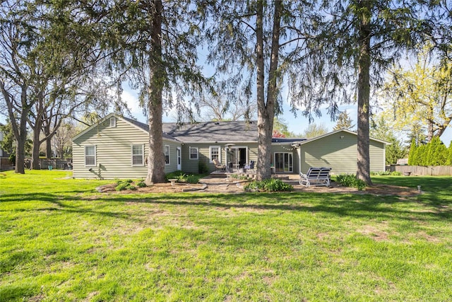 back of house with a patio area, fence, and a yard