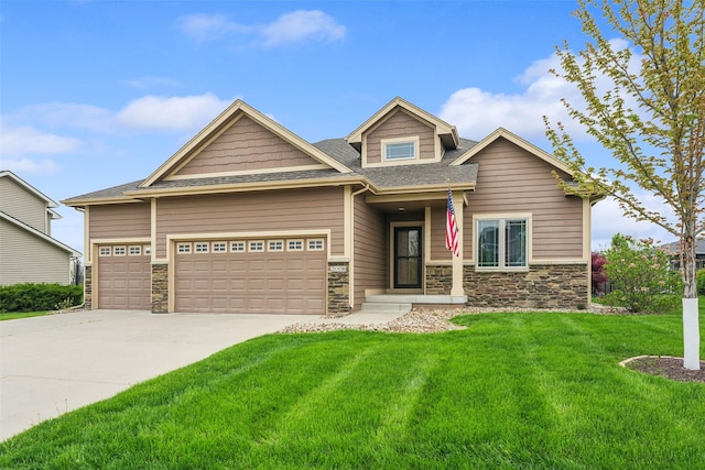 2006 NE 16th St, Ankeny, IA 50021 - craftsman house featuring a garage, a front lawn, driveway, and stone siding