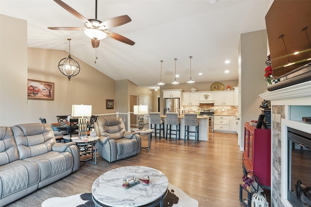 2006 NE 16th St, Ankeny, IA 50021 - living area with ceiling fan, a fireplace, light wood-type flooring, lofted ceiling, and recessed lighting