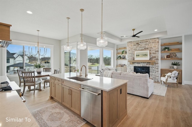 7325 NW Beaver Dr, Johnston, IA 50131 - kitchen featuring ceiling fan, a sink, dishwasher, light countertops, and light wood-type flooring