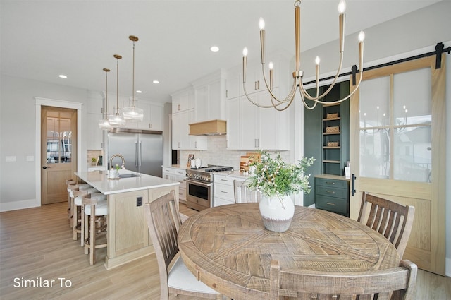 7325 NW Beaver Dr, Johnston, IA 50131 - dining space with recessed lighting, light wood-style flooring, baseboards, and an inviting chandelier