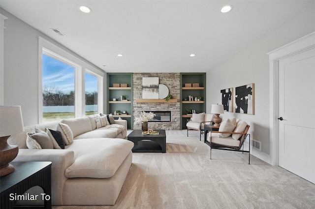 7325 NW Beaver Dr, Johnston, IA 50131 - carpeted living area with recessed lighting, built in shelves, visible vents, and a fireplace